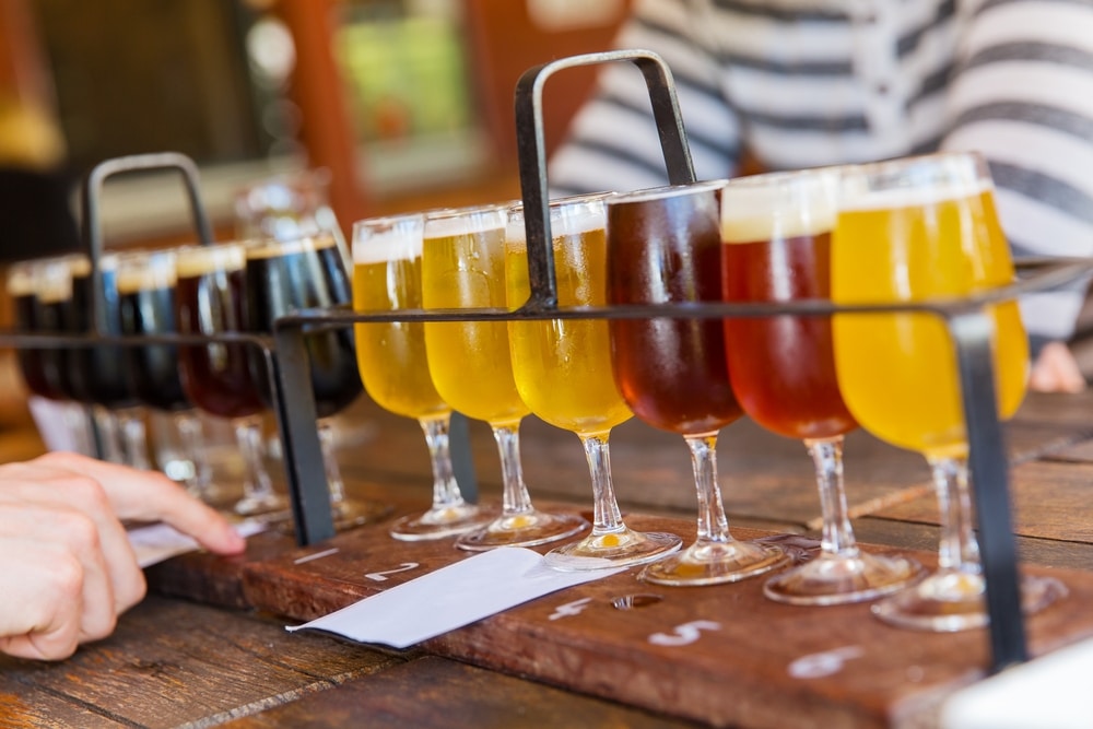 a variety of beer along a tap room bar indicating brewery sales