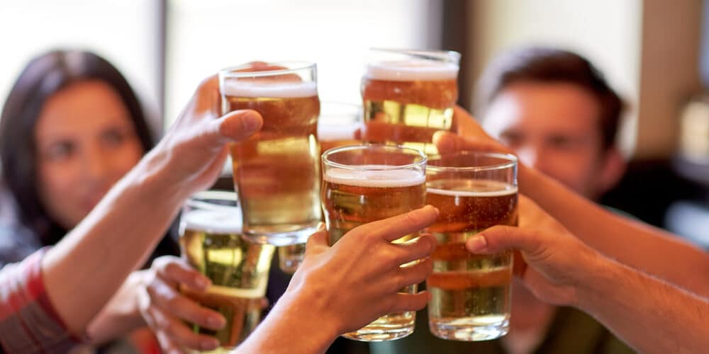 happy friends drinking beer at bar or pub