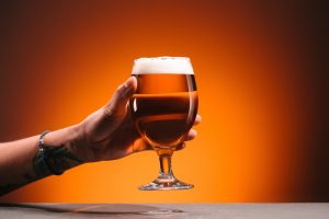 craft brewery financial training - hand holding a glass